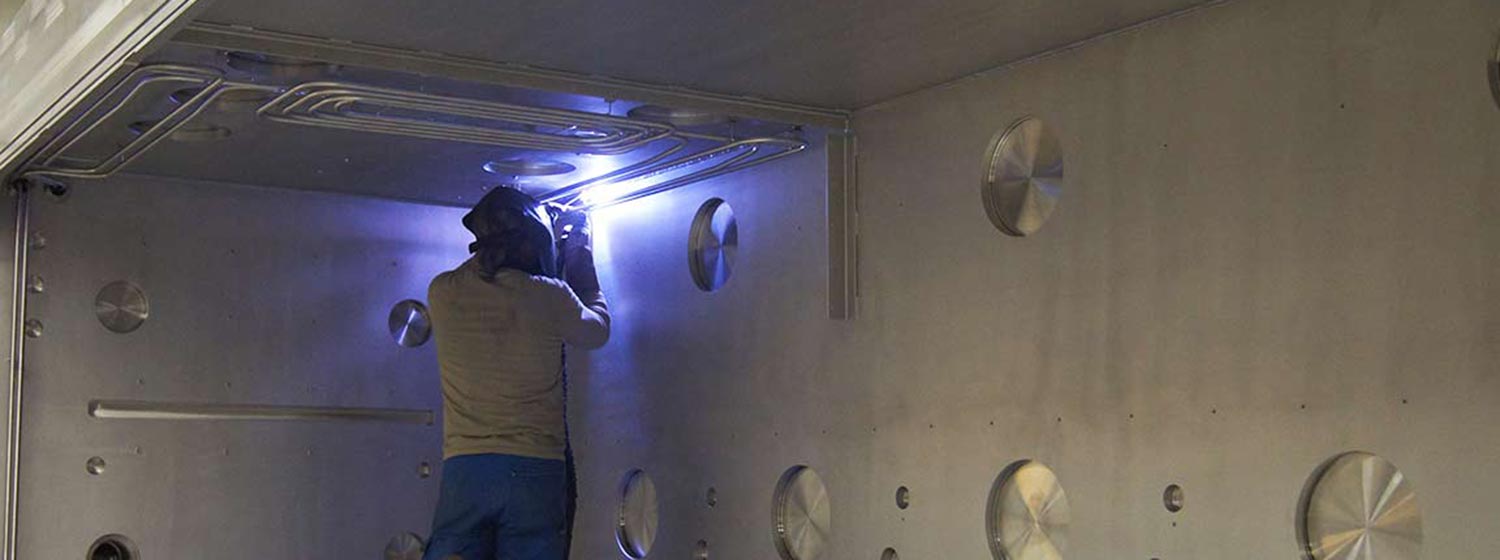 Schweißer in einer Vakuumkammer